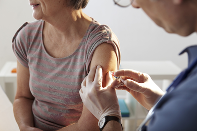 elderly woman receiving vaccine